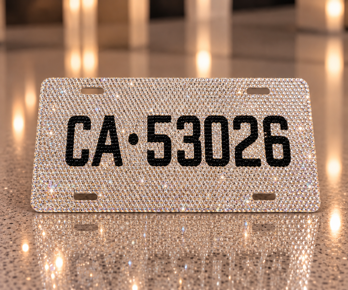 California license plate display covered in clear rhinestones on a warm reflective surface