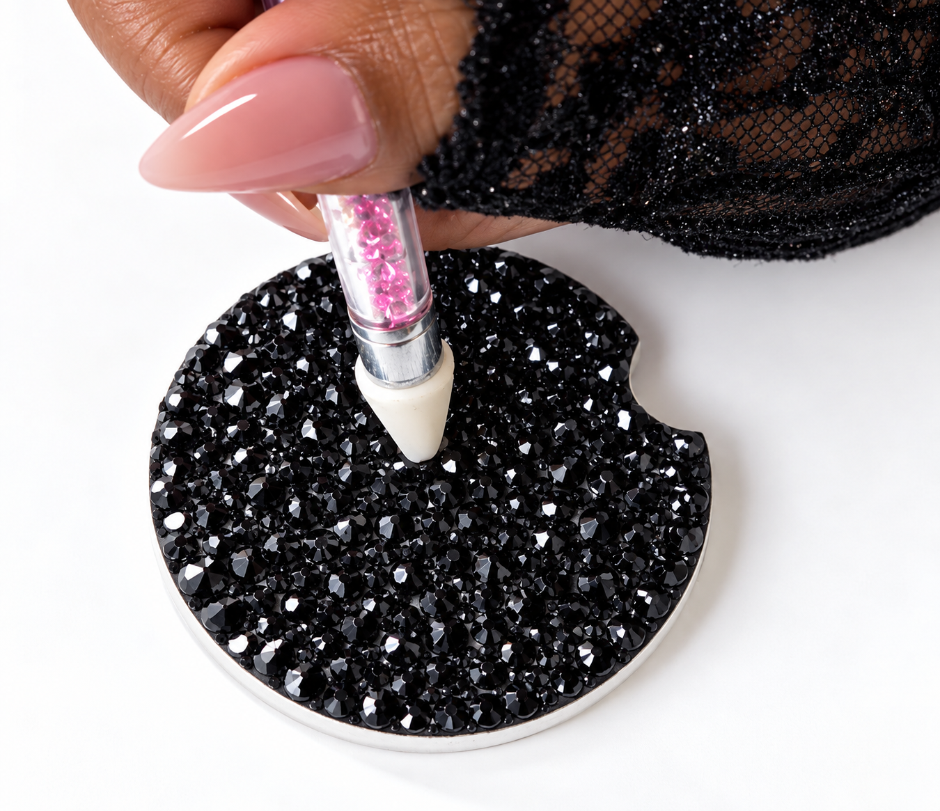 A guest uses a precision tool to place crystals during a hands-on rhinestone workshop