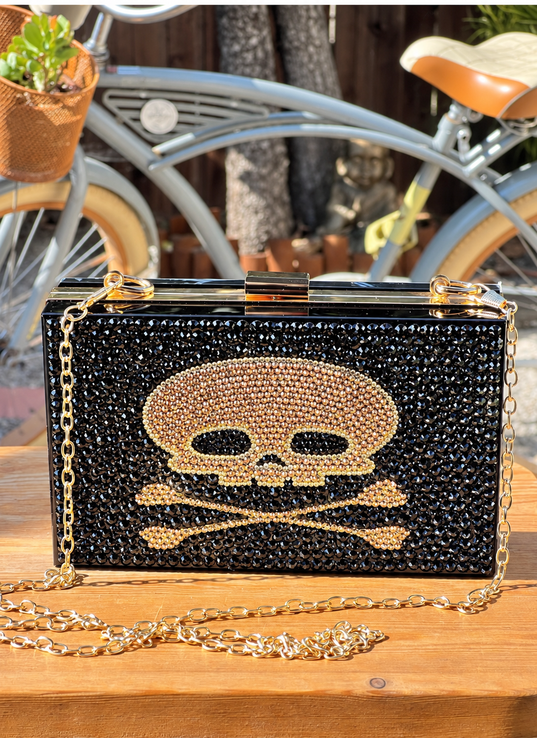 Black crystal evening purse with a gold skull-and-crossbones design