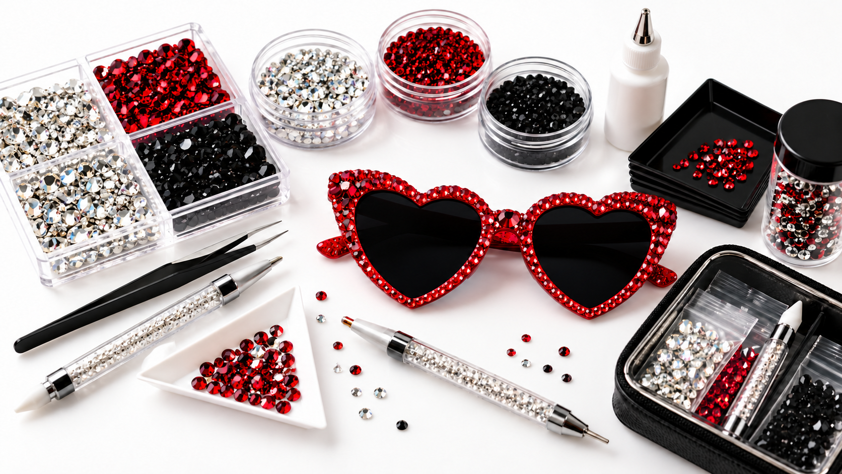 Red crystal heart sunglasses, rhinestones, and tools arranged for a So Fly Bling hands-on session