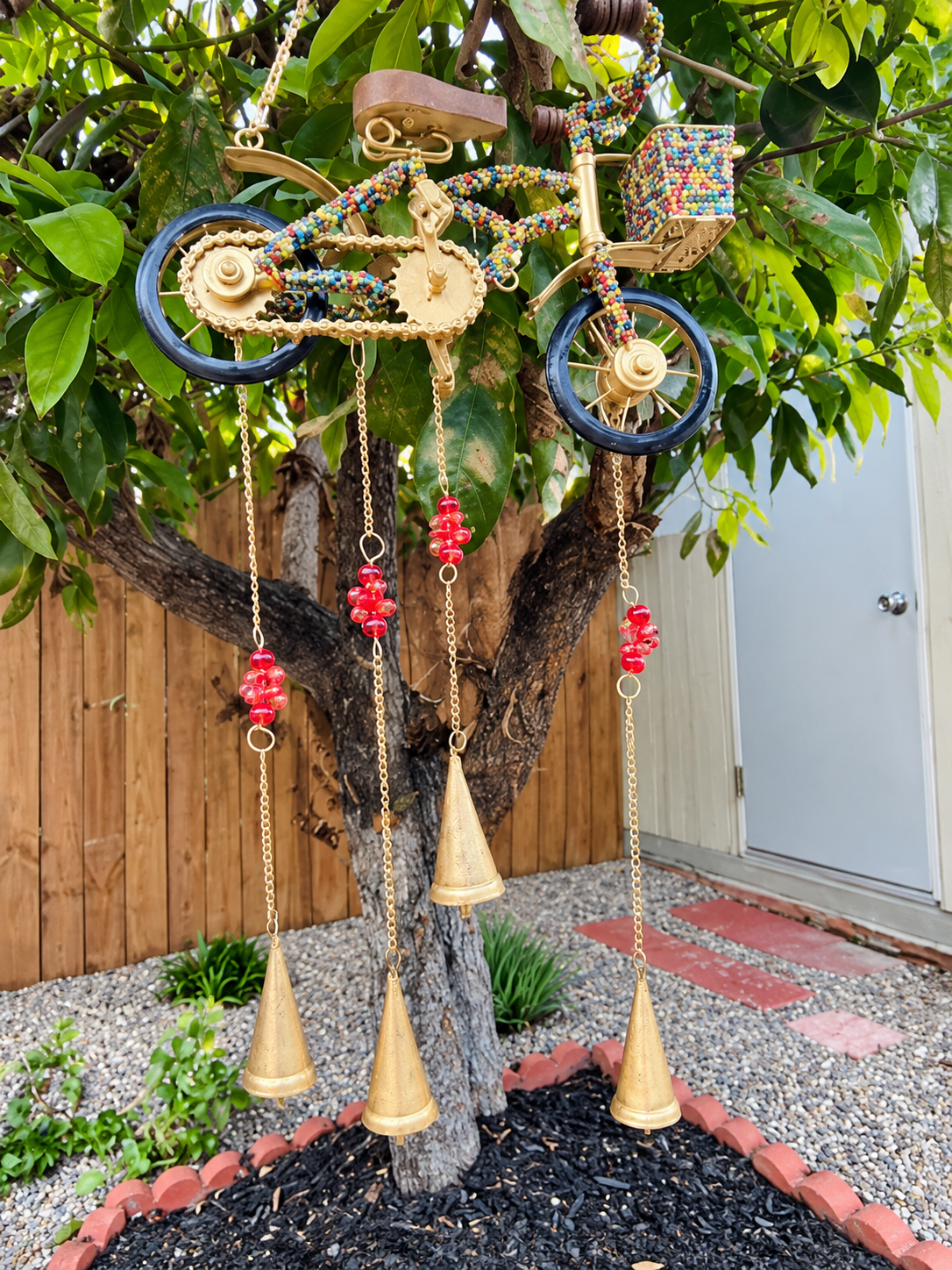 Bicycle wind chime hanging in the garden